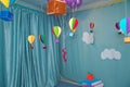 Hanging from above Colorful paper balloon with blue sky background and clouds. Origami made colorful air balloon cloud