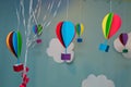 Hanging from above Colorful paper balloon with blue sky background and clouds. Origami made colorful air balloon cloud