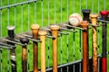 Hanging baseball bat, Baseball bats hanging on the racket holder outside the dugouts on the attachment to the fence and a baseball Royalty Free Stock Photo