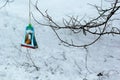 Hanging bird feeder hand made of paper box of sweets by kids after the lesson of kindness at school to save birds Royalty Free Stock Photo