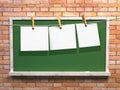Hanging blank paper on clothesline and blackboard Royalty Free Stock Photo