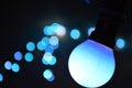 Hanging blue retro light bulb bokeh at night Royalty Free Stock Photo