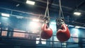 Hanging Boxing Gloves in a Ring with copy space: Concept for Fight Preparation, Athletic Training, and Protective Gear -