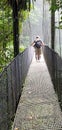 Hanging bridge crossed by tourists near La Fortuna Costa Rica Royalty Free Stock Photo