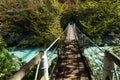 Hanging bridge over Soca river to Slap Kozjak waterfall in Triglav National Park in Slovenia Royalty Free Stock Photo