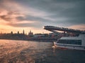 Hanging bridge at Zaryadye park, ferryboat and silhouettes of Saint Basil Cathedral and Moscow Kremlin Royalty Free Stock Photo