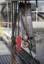 Hanging chains and hooks of a lift system in an industrial setting