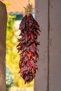 Hanging chile peppers on the outside of house as both a decoration and delicacy for cooking and spices in recipe
