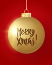 Hanging Christmas ball on red background. Merry Xmas hand drawn letters. Sparkling golden glitter bauble Royalty Free Stock Photo