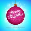 Hanging Christmas ball with sparkling metal glitter effect and Merry Christmas lettering on colorful background Royalty Free Stock Photo