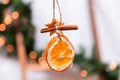 Hanging Christmas decoration of dried oranges, tangerine and cinnamon stars. holiday concept. blurred background