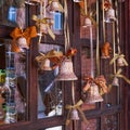 Hanging Christmas vintage bells on blurred background of old wooden window . Festive Christmas retro decor ornaments