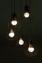 Hanging classic black metal light bulb in the dark night interior background Royalty Free Stock Photo