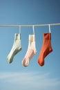 Hanging clothes cotton laundry socks pair background blue clothesline dry clothespin rope line Royalty Free Stock Photo