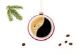 Hanging coffee cup as Christmas ball with flying beans and fir tree branch isolated on white Royalty Free Stock Photo