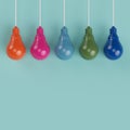 Hanging colorful pantone pastel light bulbs different idea. Royalty Free Stock Photo
