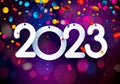 Hanging 2023 on colorful purple confetti background