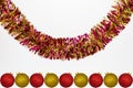 Hanging colorful tinsel with red and gold Christmas baubles, isolated on a white background with copy space, christmas decorations Royalty Free Stock Photo