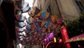 Hanging colorful umbrellas. Action. Bottom view of old umbrellas hanging on street of city. Hanging umbrellas decorating