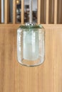 Hanging crystal lamp, reading night light bedroom accent, wooden panel in the background