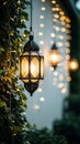 Hanging decorative lantern with lights and ivy in blurred background Royalty Free Stock Photo