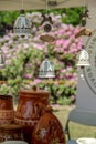 Hanging delicate handmade ceramic bells and some pots in the background Royalty Free Stock Photo