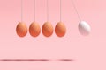 Hanging eggs designed as Newton& x27;s cradle balance pendulum balls on pink background Royalty Free Stock Photo