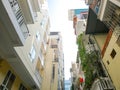 Hanging garden on caged-balcony apartment blocks, multistory building along small back alley in downtown Hanoi, Vietnam, row of Royalty Free Stock Photo