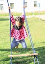 Hanging girl on swing Royalty Free Stock Photo