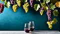 Hanging grapes 2 glasses with wine on marble table green wall background grape design Royalty Free Stock Photo