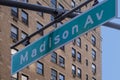 Hanging green and white city street sign of Madison ave, avenue Royalty Free Stock Photo