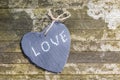 Hanging heart and wooden background in country style. Royalty Free Stock Photo