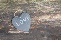 Hanging heart and wooden background in country style. Royalty Free Stock Photo