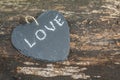 Hanging heart and wooden background in country style. Royalty Free Stock Photo