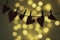 Hanging hearts joined by small tweezers with bokeh of lights from behind Royalty Free Stock Photo