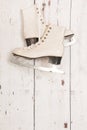 Hanging ice skates on wooden wall Royalty Free Stock Photo