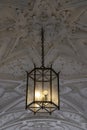 Hanging lamp made of iron and glass in the decorated vaulted ceiling in the entrance to the Schloss Johannisburg in Aschaffenburg
