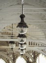 The hanging lanterns in white wooden colonnade Karlovy Vary. Bohemia. Czech Republic. Symmetrical hanging old-style street light