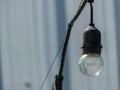 hanging light bulb outside creates a captivating and inviting atmosphere, casting a warm and gentle glow in outdoor spaces. Royalty Free Stock Photo