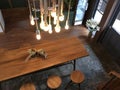 Hanging Light bulbs over long wooden coffee table