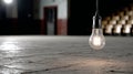 Hanging lightbulb in an empty dimly lit room. Royalty Free Stock Photo