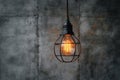 Hanging lightbulb industrial concept on cement background design Royalty Free Stock Photo