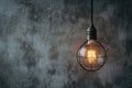 Hanging lightbulb industrial concept on cement background design Royalty Free Stock Photo