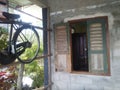 Hanging old bicycle near window Royalty Free Stock Photo