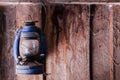 Hanging old lantern with cobweb on wooden wall. Royalty Free Stock Photo