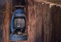 Hanging old lantern with cobweb on wooden wall. Royalty Free Stock Photo