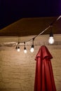 Hanging outdoor lights over patio in summer night