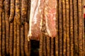 Hanging pork meat and sausages in smokehouse