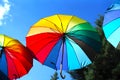 Hanging rainbow umbrellas on blue sky background Royalty Free Stock Photo