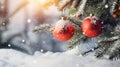 Hanging red Christmas balls on spruce and fir branches with snow covered surface. Royalty Free Stock Photo